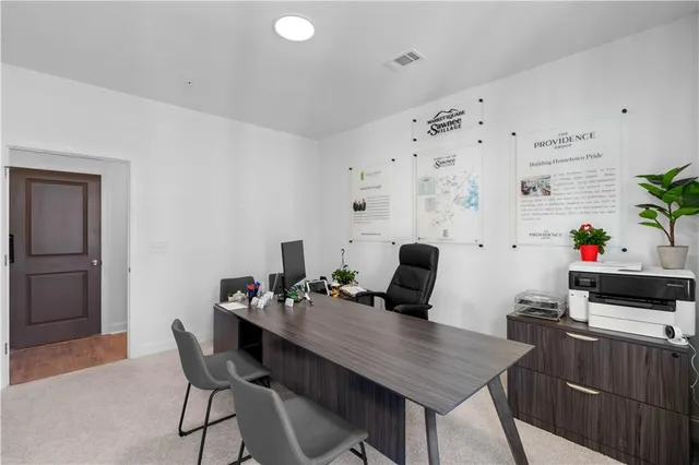 a view of a workspace with furniture