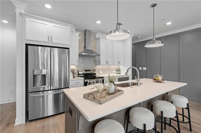 a kitchen with granite countertop a sink stove and refrigerator