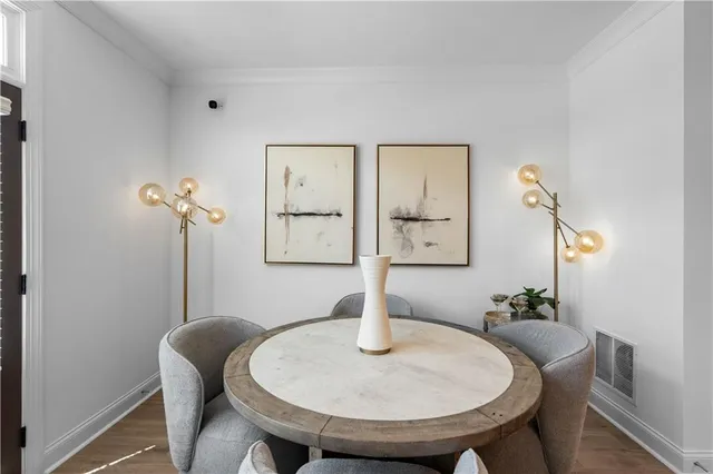 a dining room with furniture and wooden floor