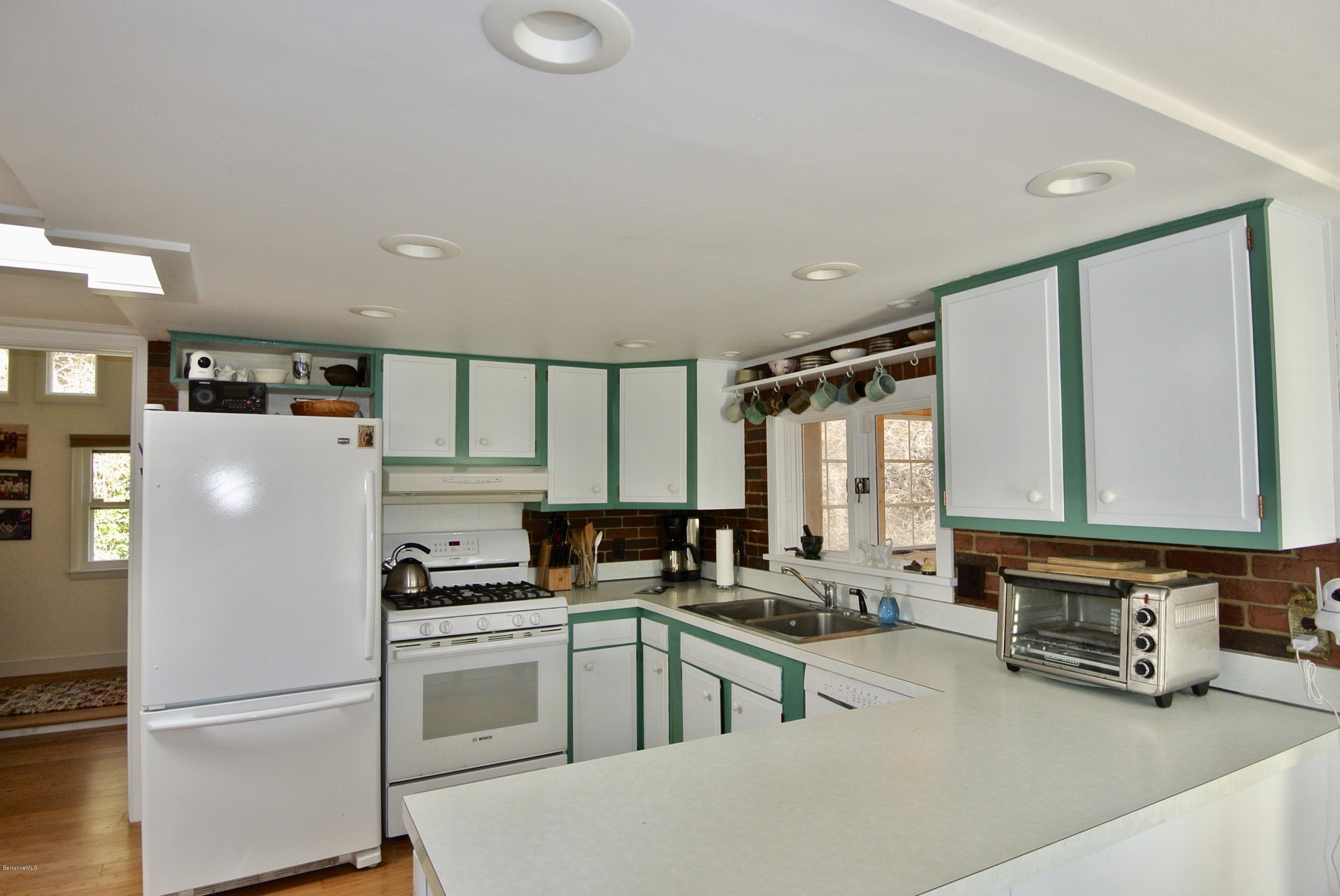 6 Mahkeenac Road Stockbridge, MA 01262 - Photo 12 of 20 a kitchen with a refrigerator and a sink