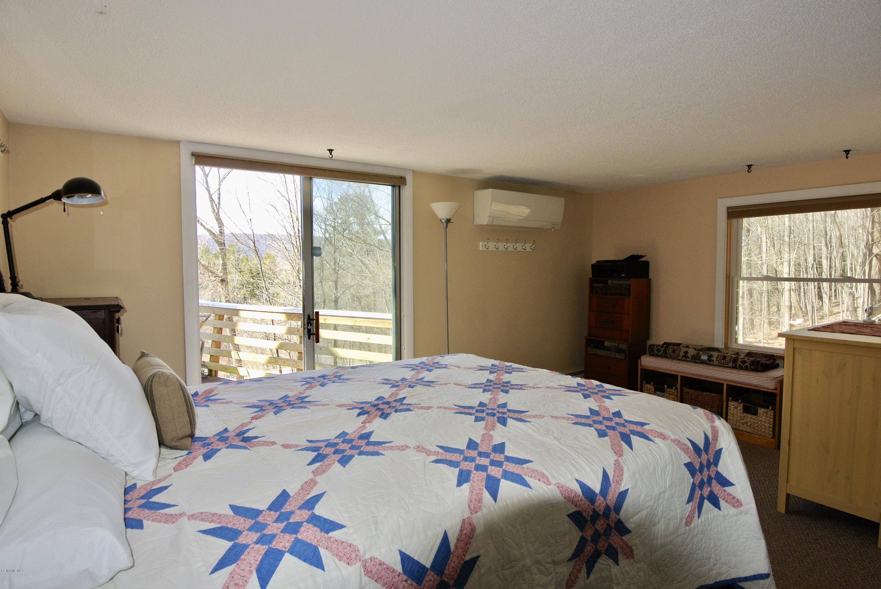 6 Mahkeenac Road Stockbridge, MA 01262 - Photo 14 of 20 a bedroom with a bed and a table