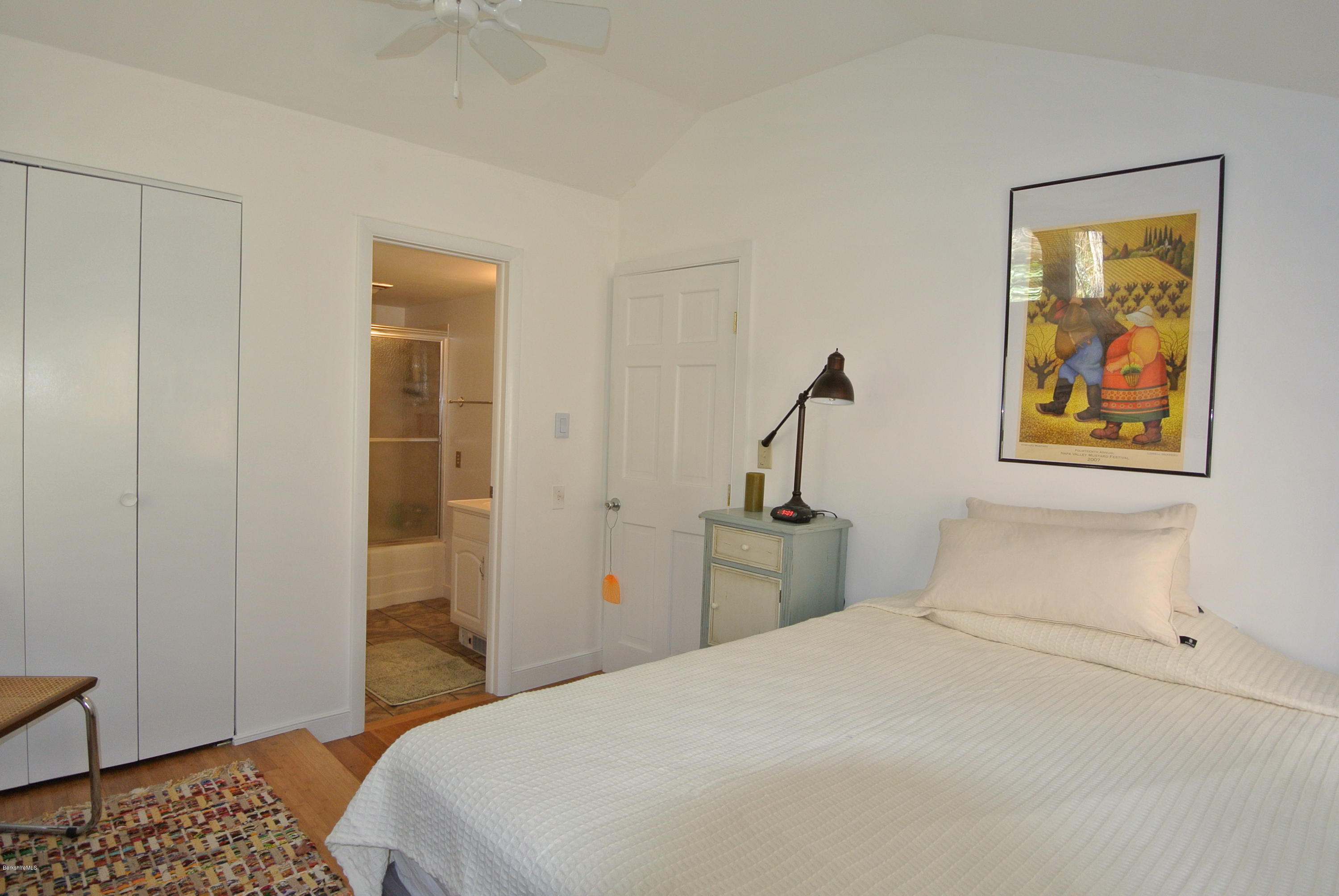 6 Mahkeenac Road Stockbridge, MA 01262 - Photo 17 of 20 a bedroom with a bed and a painting on the wall