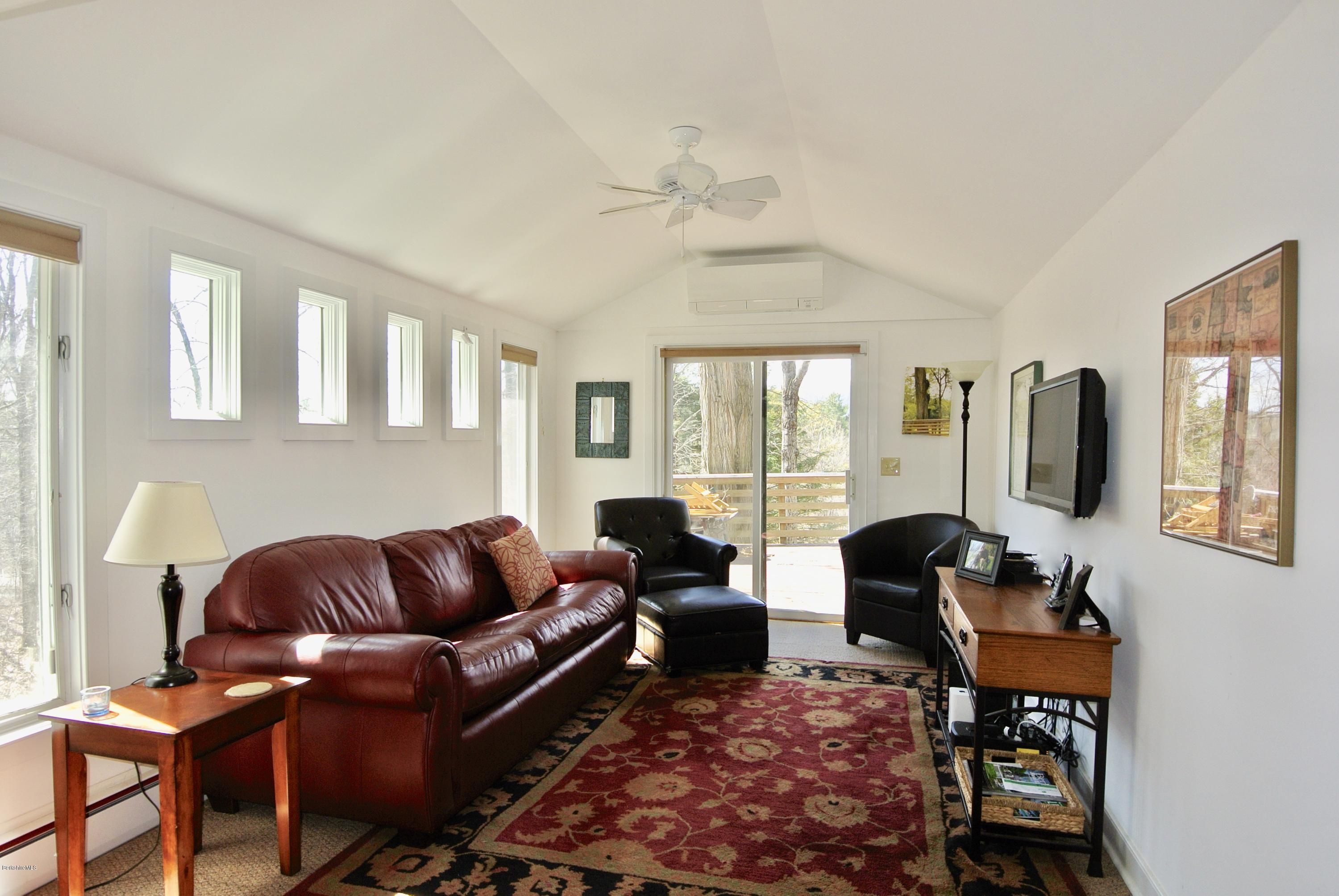 6 Mahkeenac Road Stockbridge, MA 01262 - Photo 3 of 20 a living room with furniture ceiling fan and a rug