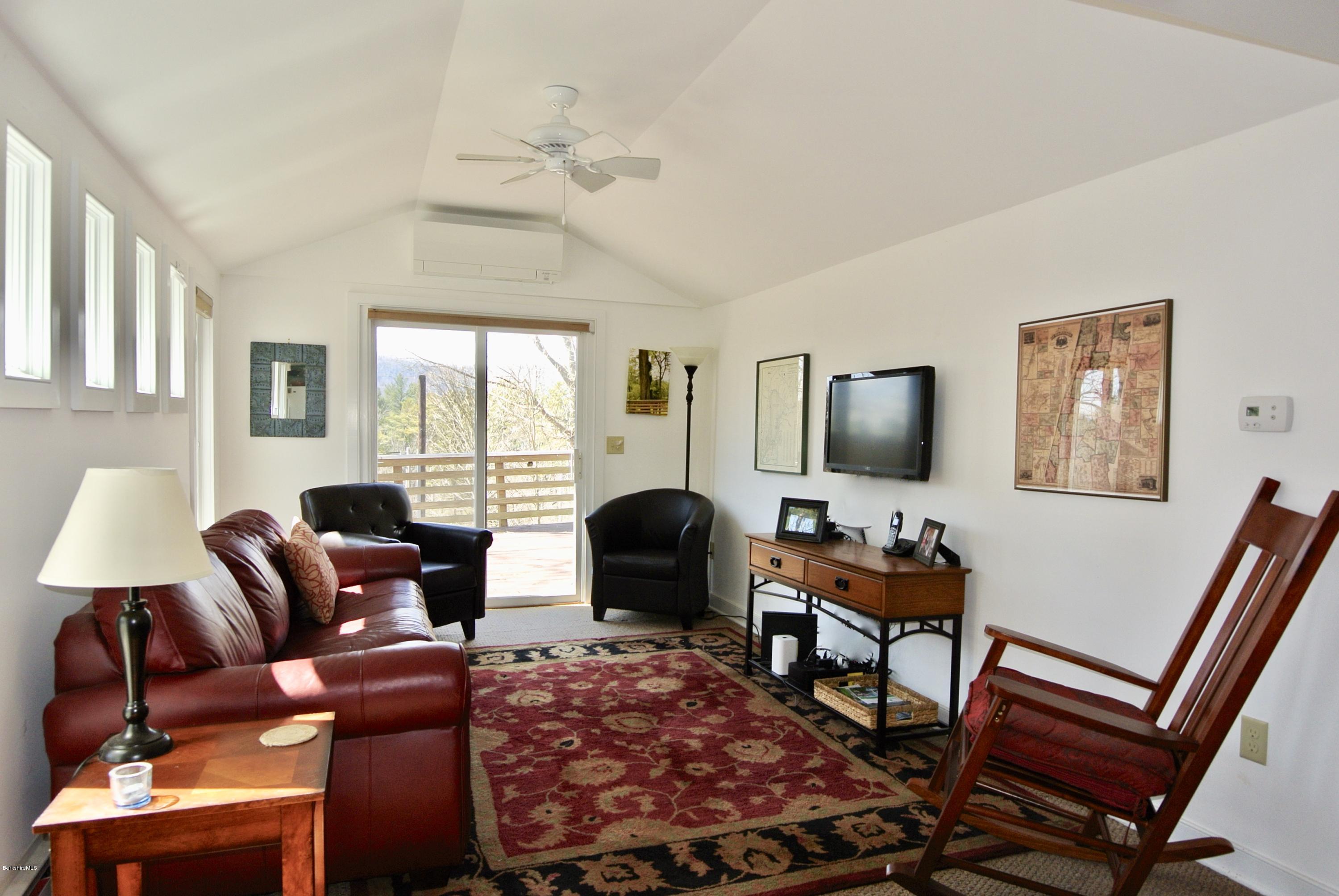 6 Mahkeenac Road Stockbridge, MA 01262 - Photo 4 of 20 a living room with furniture a flat screen tv and a large window