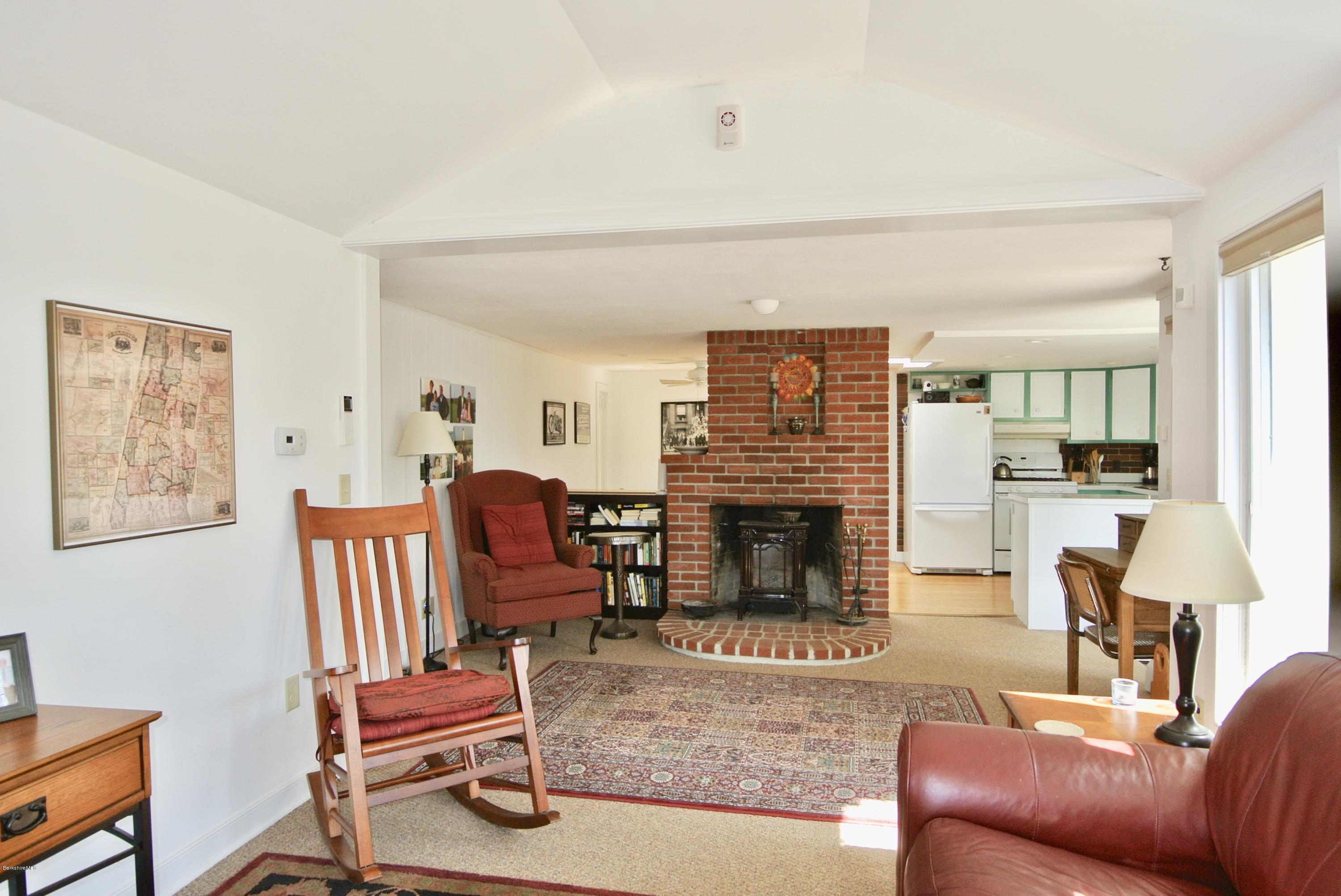 6 Mahkeenac Road Stockbridge, MA 01262 - Photo 6 of 20 a living room with furniture a flat screen tv and a fireplace