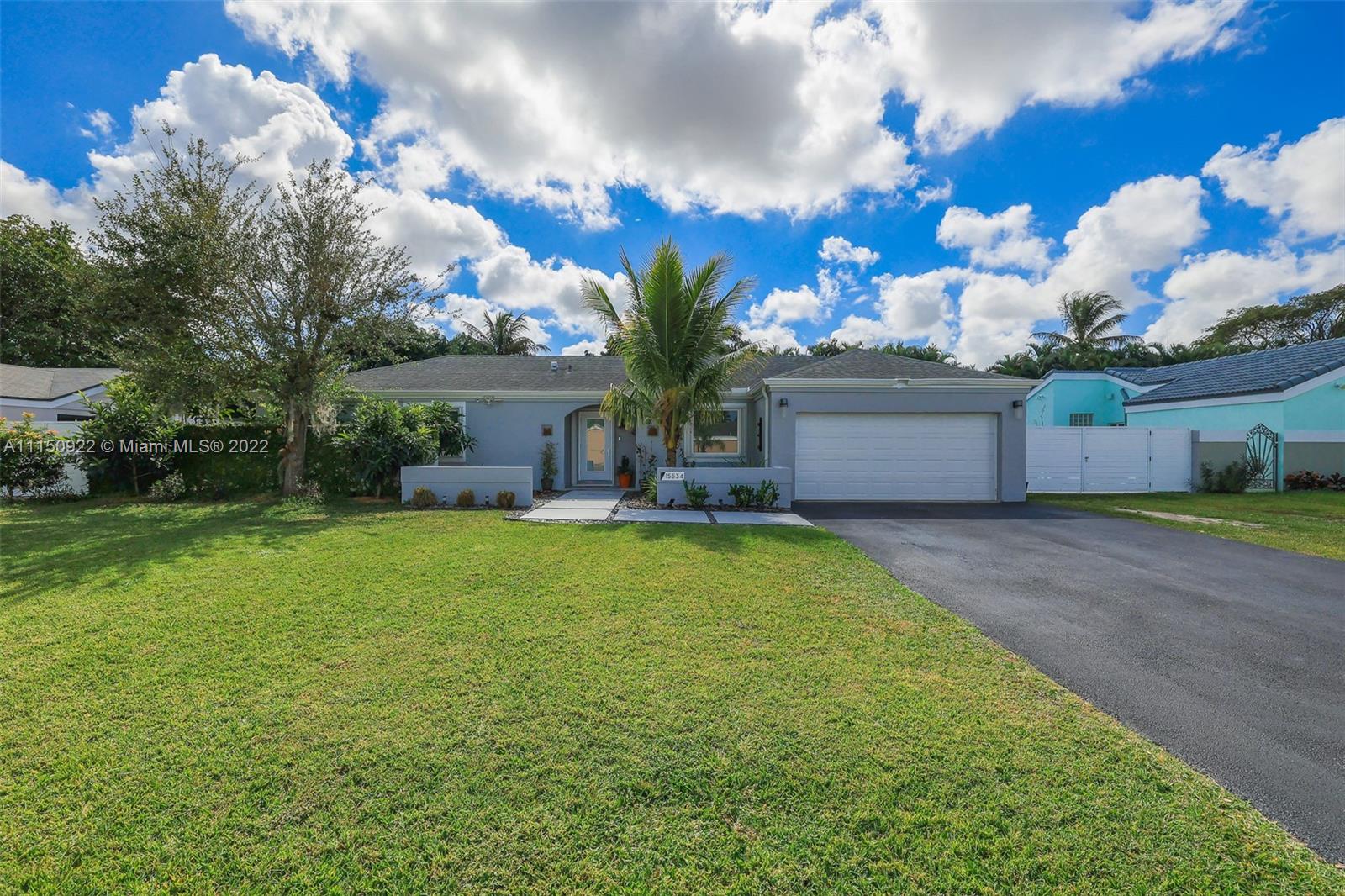 15534 Southwest 153rd Street Miami, FL 33187 - Photo 1 of 44 a front view of a house with garden