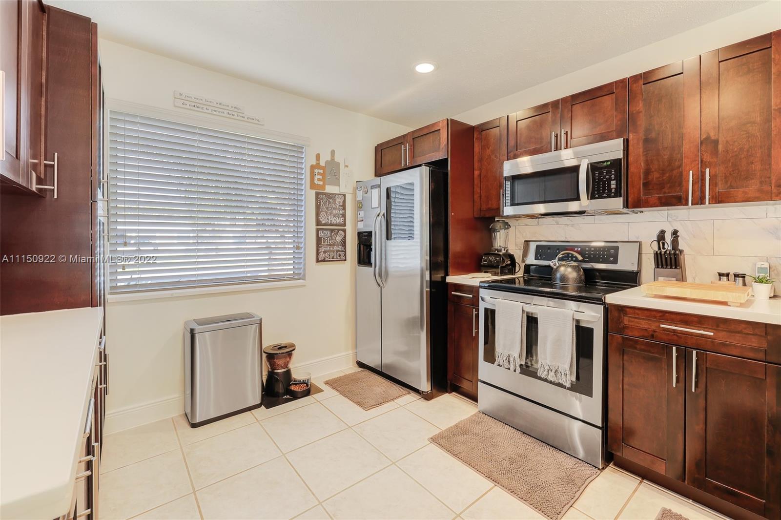 15534 Southwest 153rd Street Miami, FL 33187 - Photo 15 of 44 a kitchen with stainless steel appliances granite countertop a refrigerator and a stove top oven