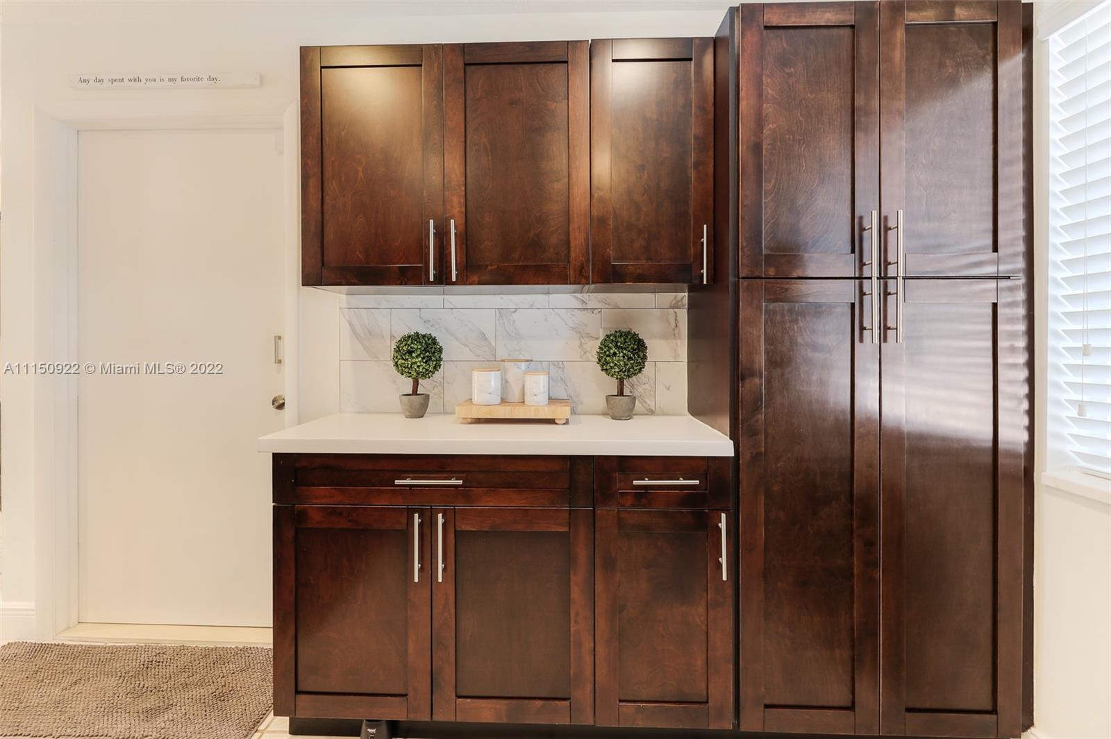 15534 Southwest 153rd Street Miami, FL 33187 - Photo 17 of 44 a sink with a wooden cabinets