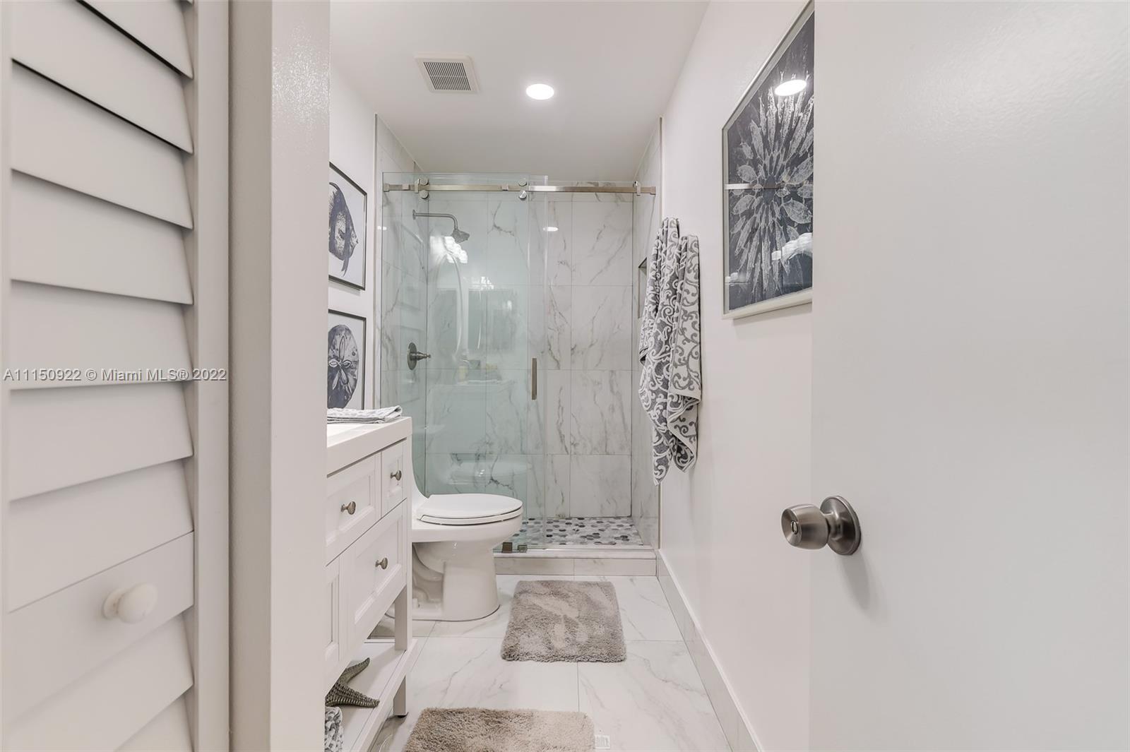 15534 Southwest 153rd Street Miami, FL 33187 - Photo 19 of 44 a bathroom with a shower a toilet and a shower