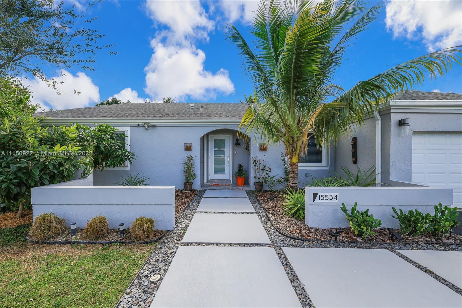 15534 Southwest 153rd Street Miami, FL 33187 - Photo 2 of 44 a front view of a house with garden