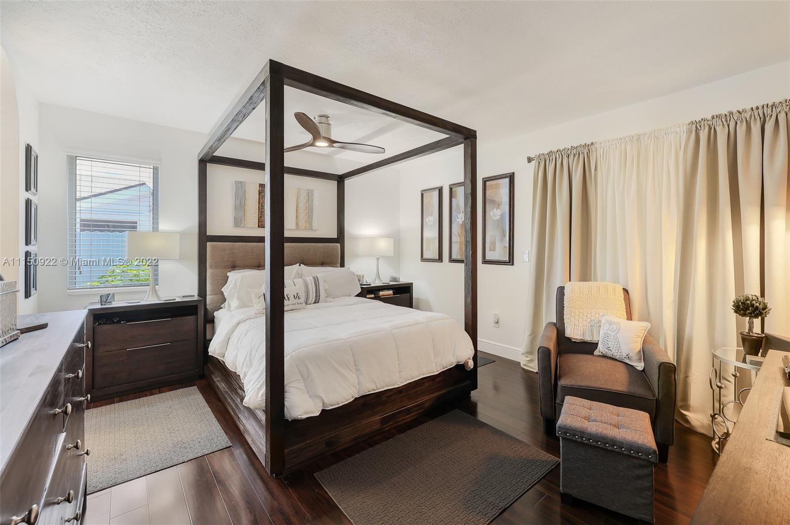 15534 Southwest 153rd Street Miami, FL 33187 - Photo 26 of 44 a bedroom with a bed couch and a window