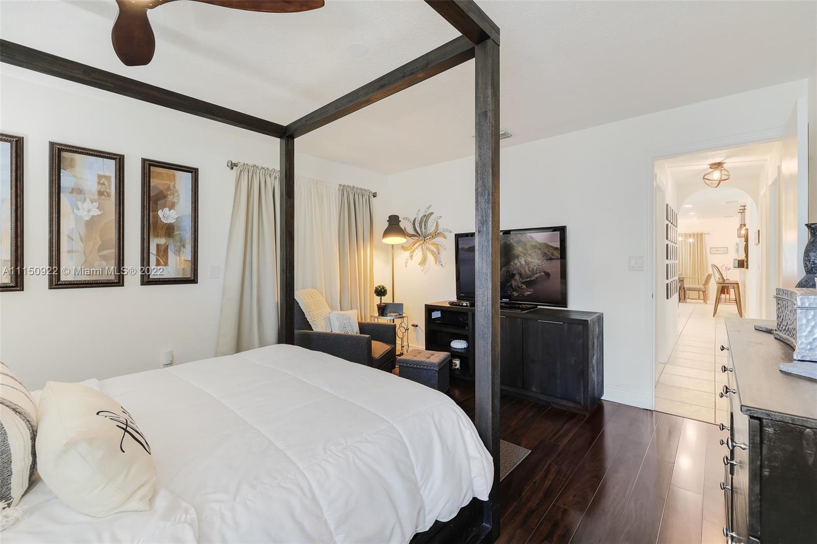 15534 Southwest 153rd Street Miami, FL 33187 - Photo 27 of 44 a bedroom with a bed and wooden floor