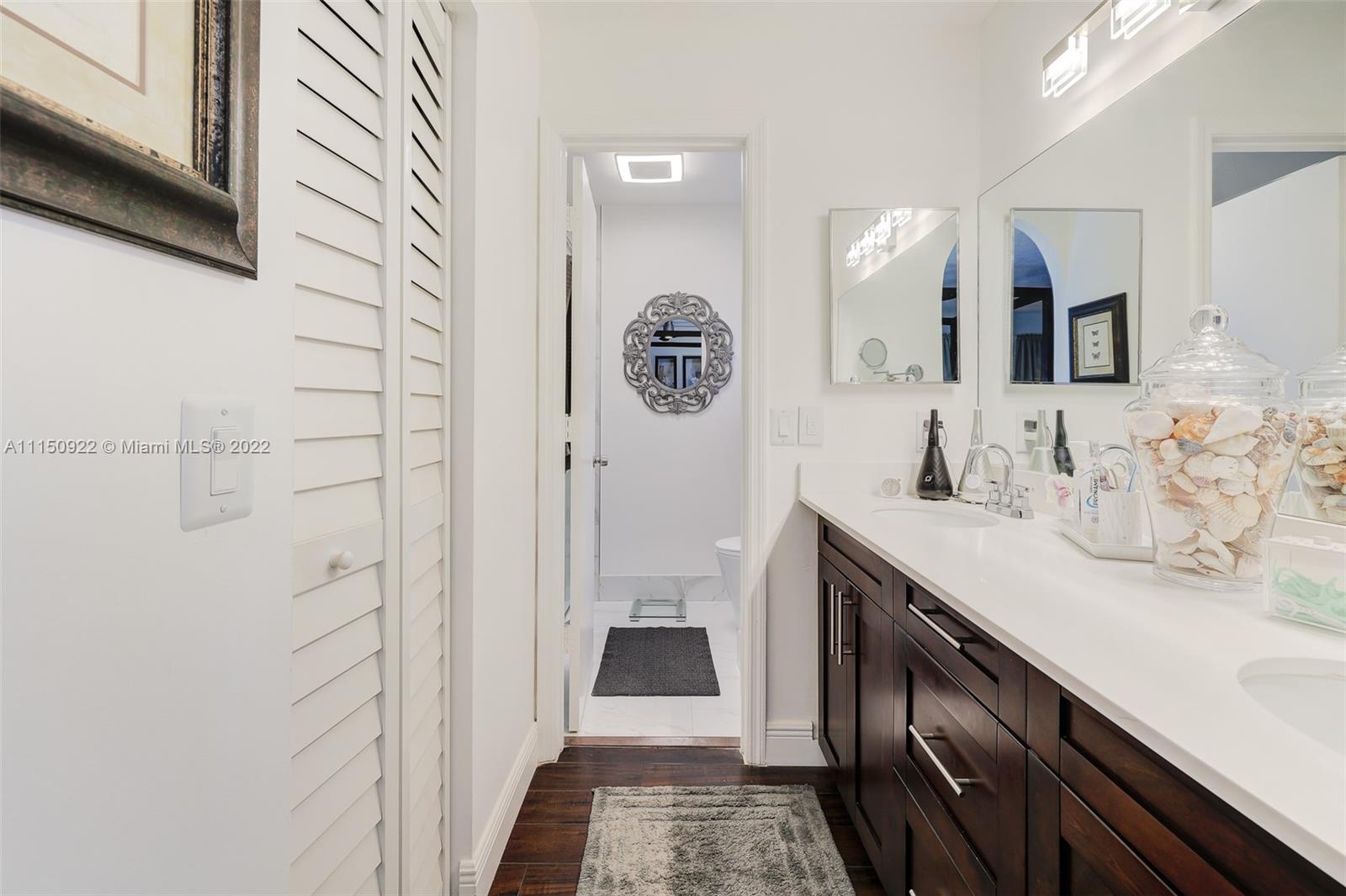 15534 Southwest 153rd Street Miami, FL 33187 - Photo 29 of 44 a bathroom with a sink a toilet and shower