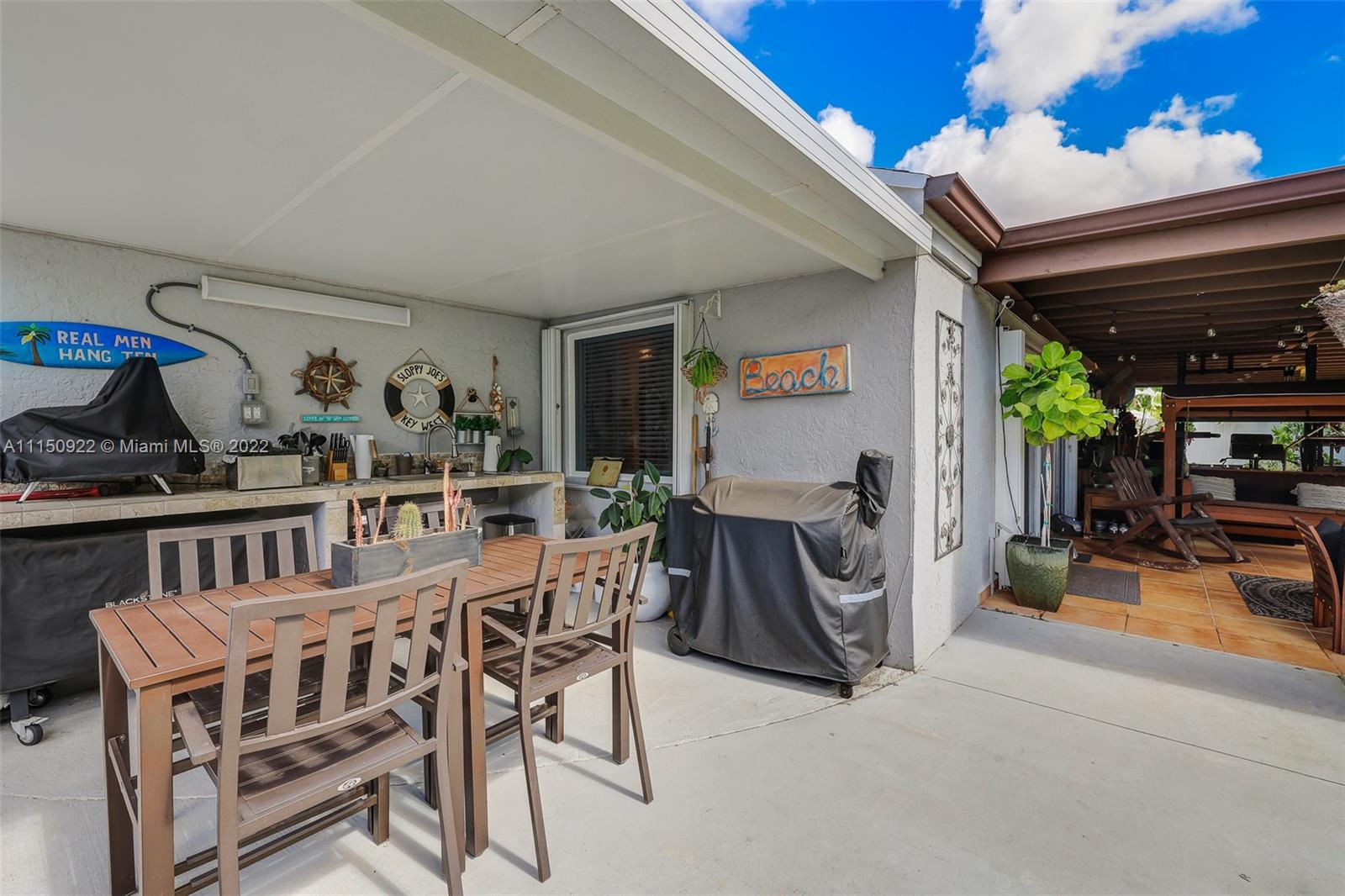 15534 Southwest 153rd Street Miami, FL 33187 - Photo 33 of 44 a view of a chairs and table in a patio