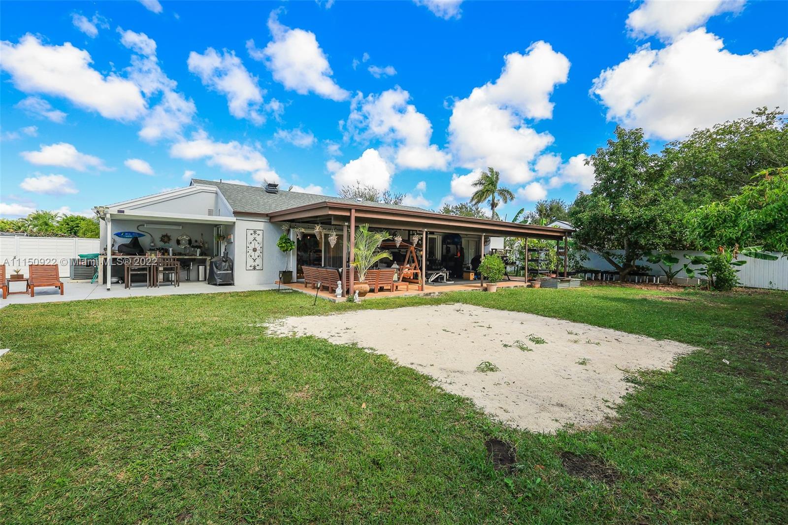 15534 Southwest 153rd Street Miami, FL 33187 - Photo 37 of 44 a view of house with outdoor space porch and garden
