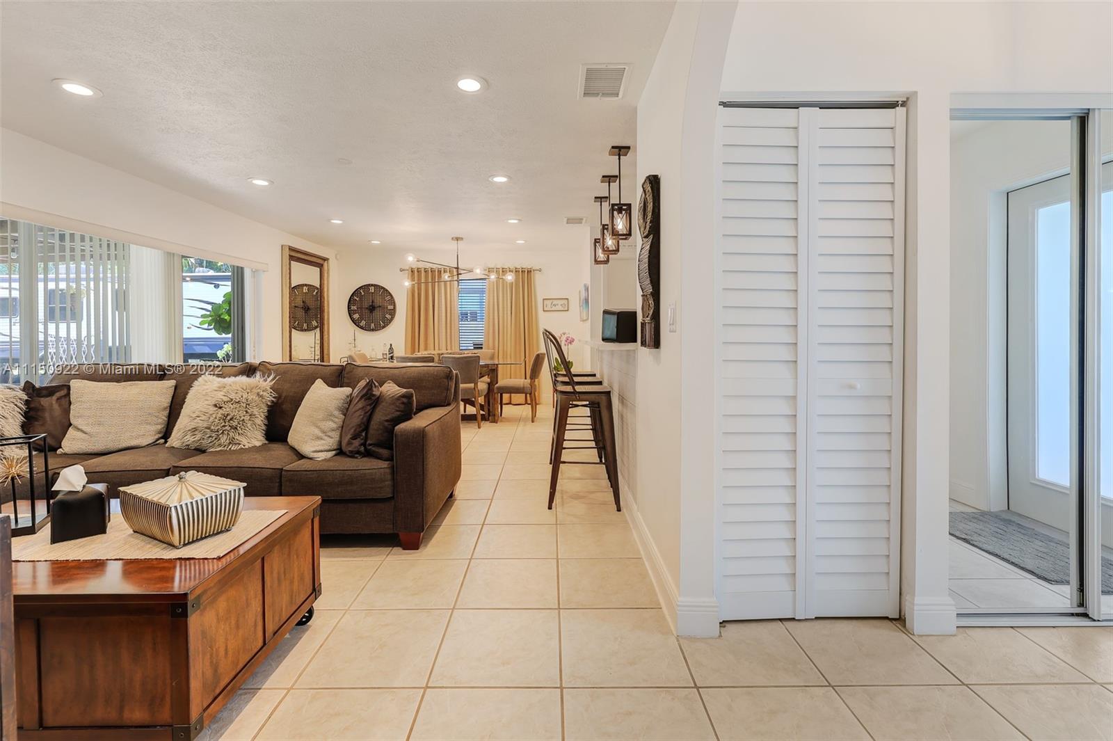 15534 Southwest 153rd Street Miami, FL 33187 - Photo 4 of 44 a living room with furniture and a walk in closet