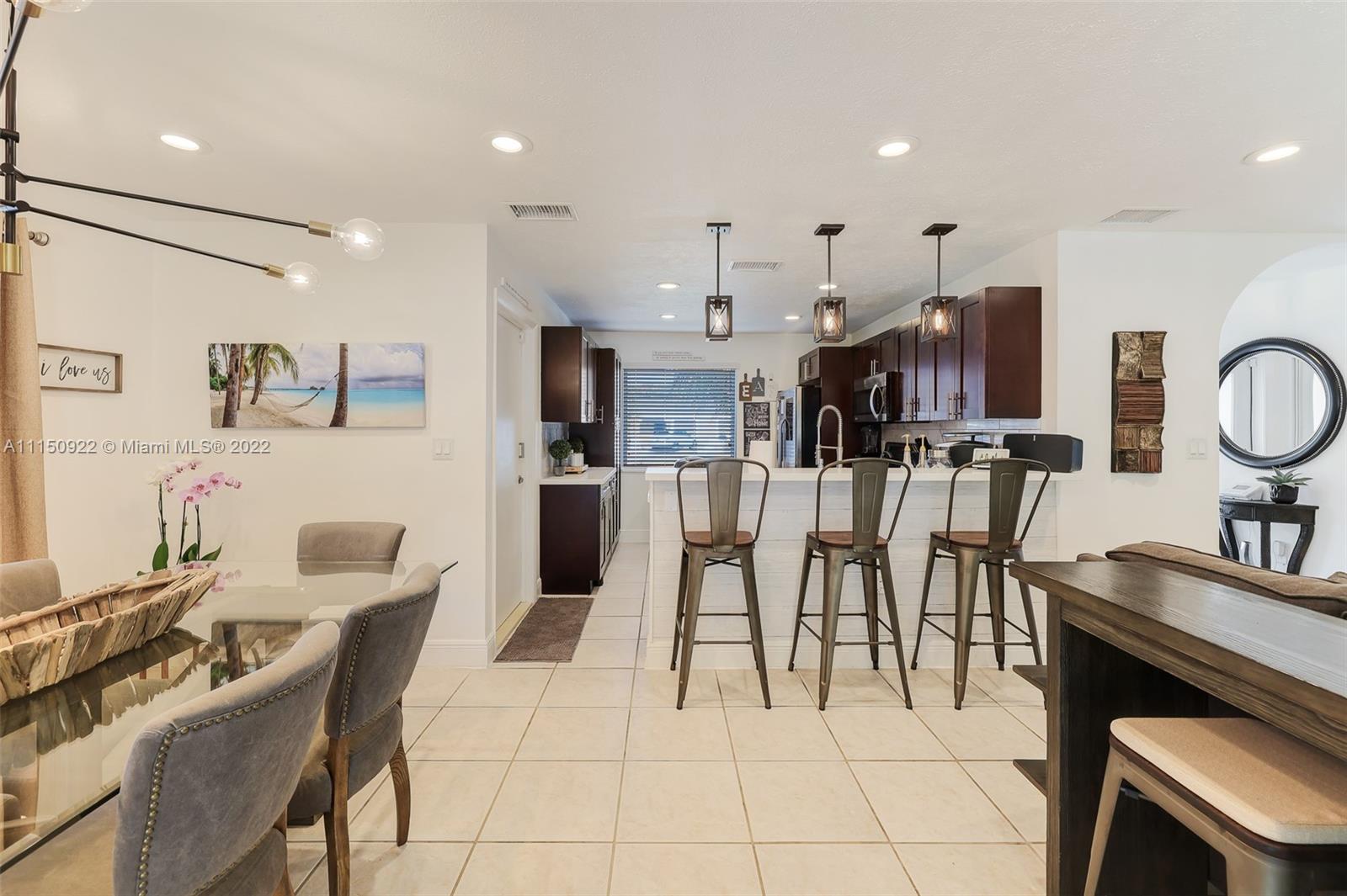15534 Southwest 153rd Street Miami, FL 33187 - Photo 7 of 44 a large kitchen with stainless steel appliances kitchen island granite countertop a sink and a refrigerator