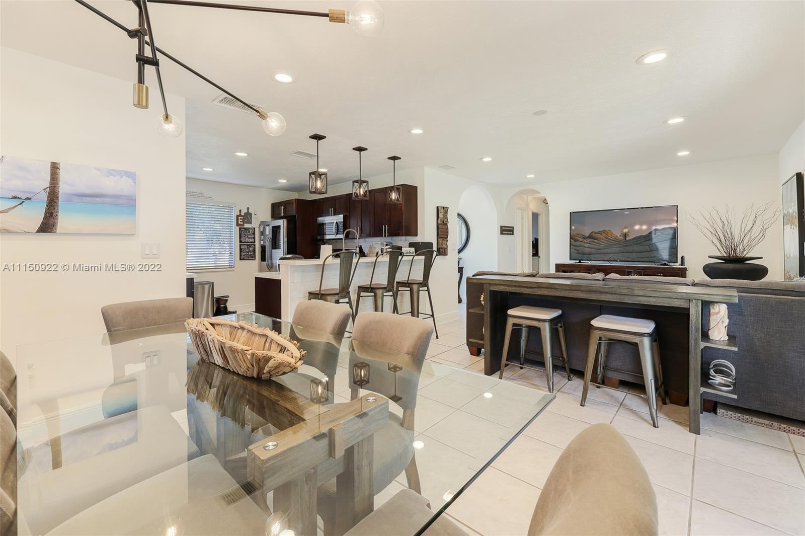 15534 Southwest 153rd Street Miami, FL 33187 - Photo 10 of 44 a living room with stainless steel appliances furniture and a kitchen view