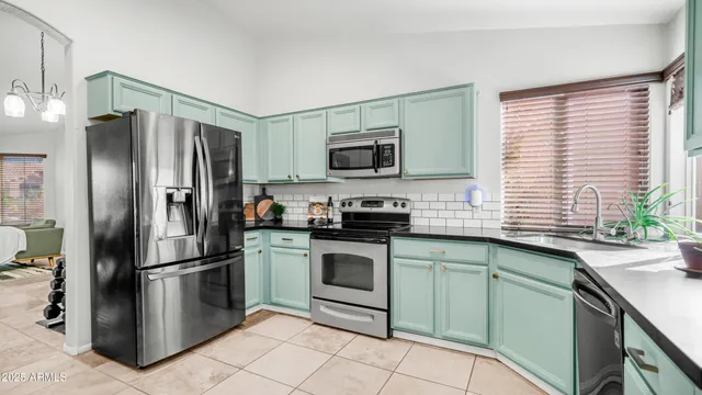 a kitchen with a table and chairs in it