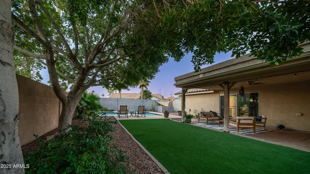 a view of a house with backyard porch and sitting area