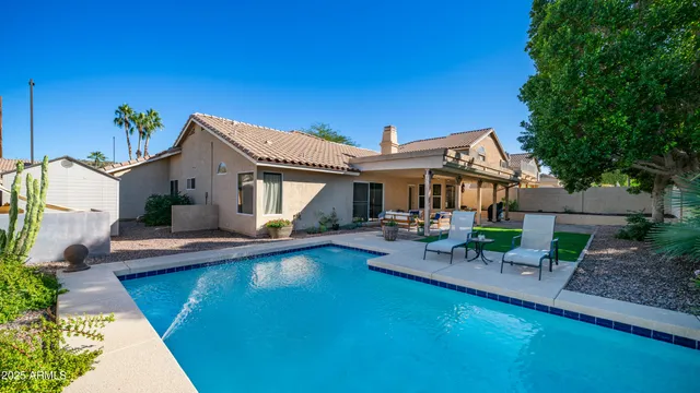 a view of a house with a yard and potted plants