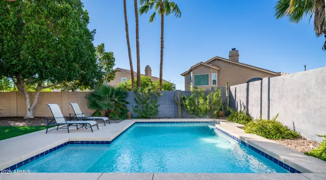 a view of a patio with a table and chairs and potted plants