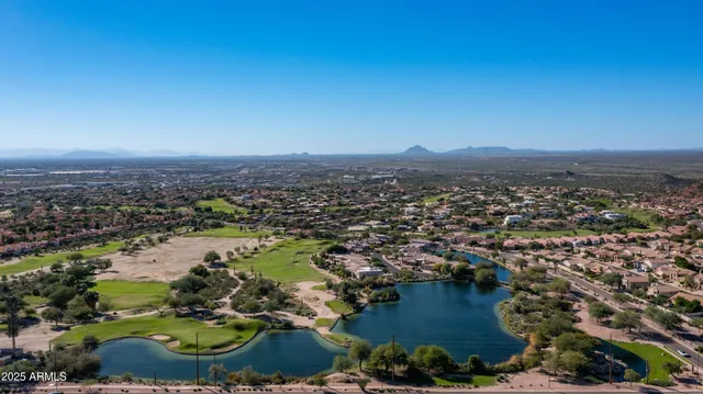 an aerial view of a house with a lake view