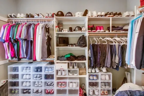 a view of walk in closet with clothes and shoes