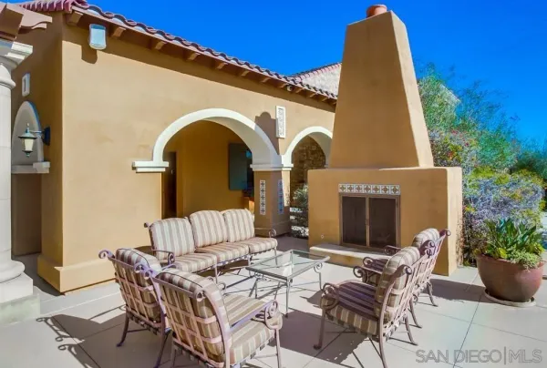 a view of backyard of house with seating space