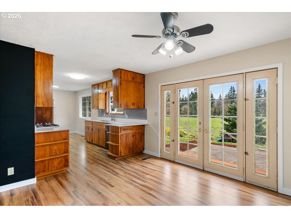 1611 Main Street Lyons, OR 97358 - Photo 17 of 48 a living room with stainless steel appliances kitchen island granite countertop a refrigerator a stove a sink with wooden cabinets and wooden floor