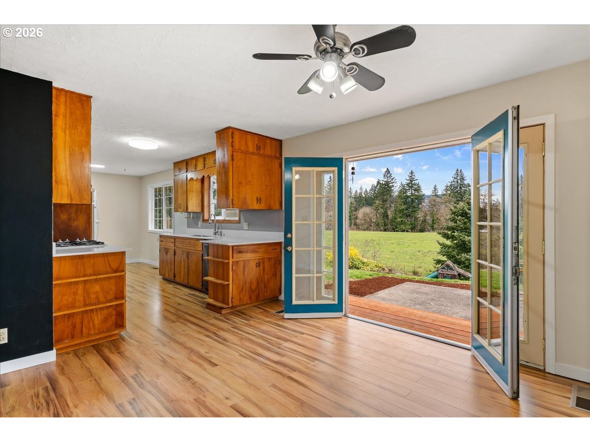 1611 Main Street Lyons, OR 97358 - Photo 18 of 48 a living room with stainless steel appliances kitchen island granite countertop furniture and a large window