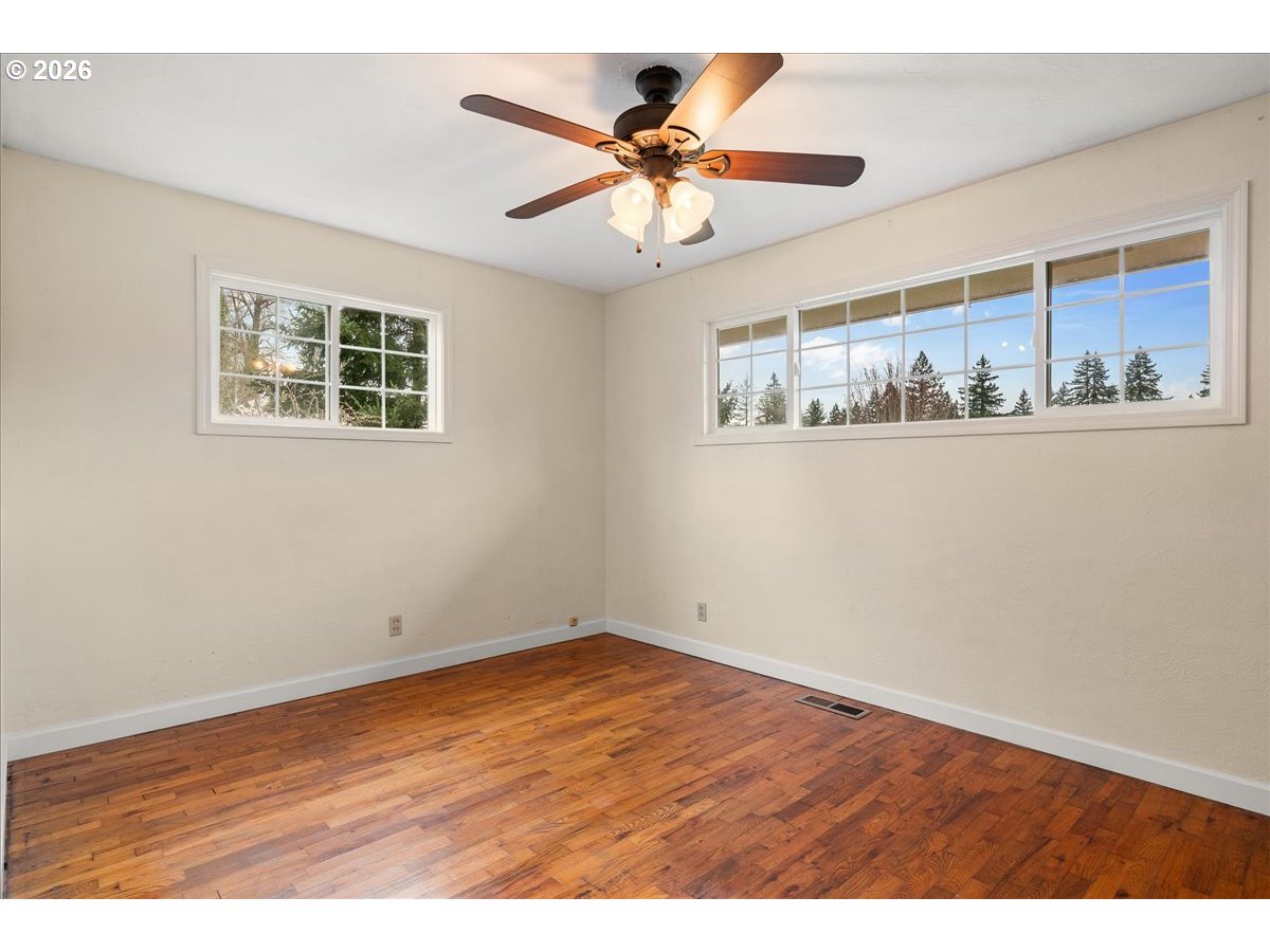 1611 Main Street Lyons, OR 97358 - Photo 22 of 48 an empty room with wooden floor and ceiling fan