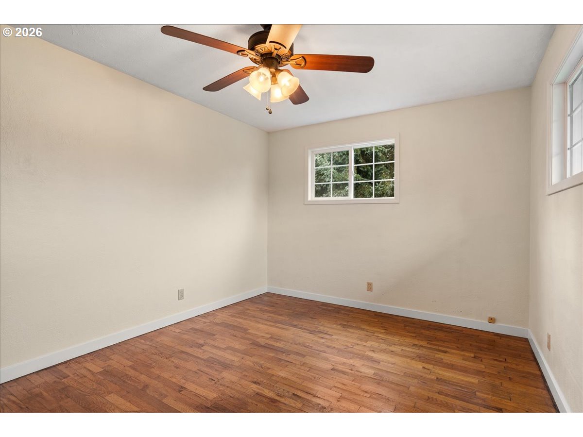 1611 Main Street Lyons, OR 97358 - Photo 23 of 48 an empty room with a window and a ceiling fan
