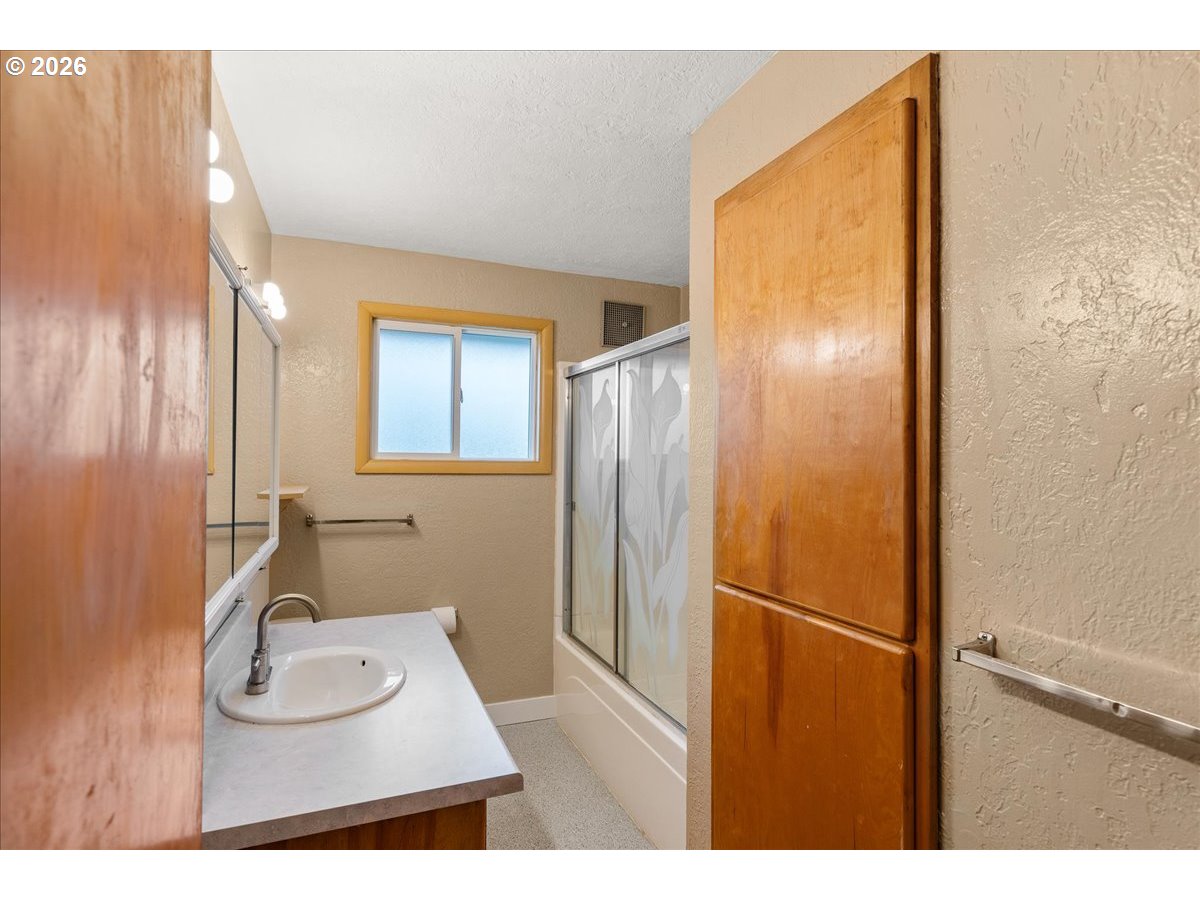 1611 Main Street Lyons, OR 97358 - Photo 26 of 48 a bathroom with a sink a mirror and shower
