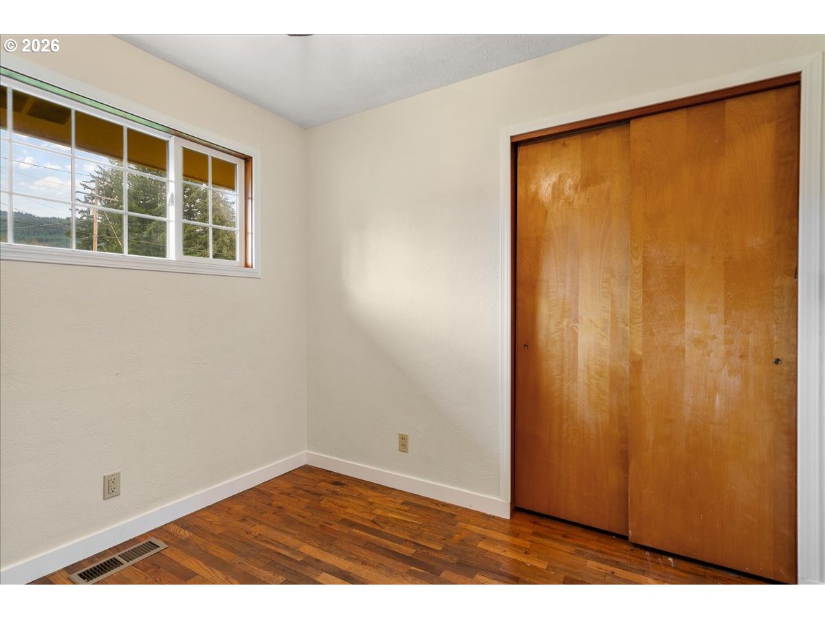 1611 Main Street Lyons, OR 97358 - Photo 29 of 48 a view of an empty room with wooden floor and a window
