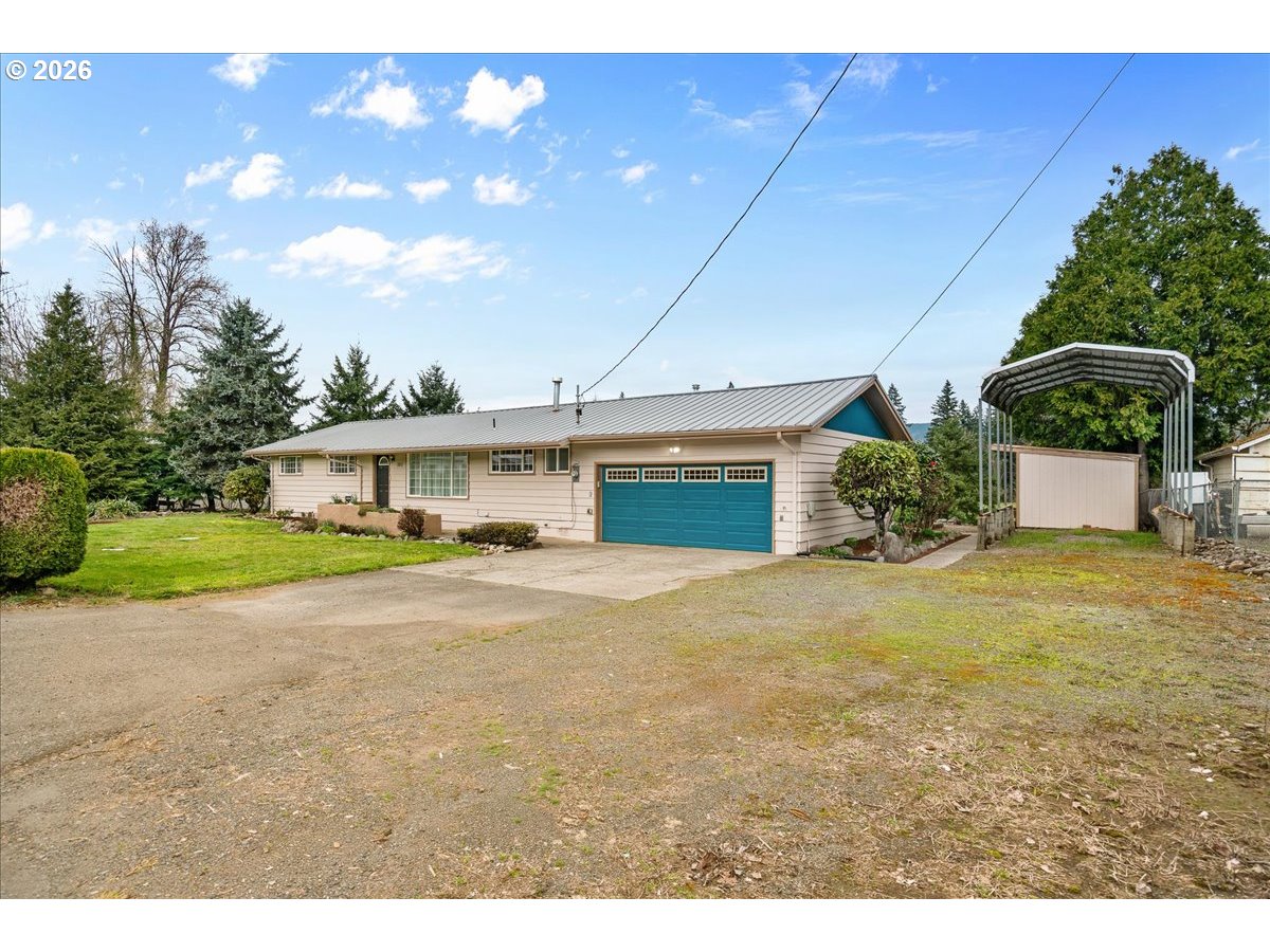 1611 Main Street Lyons, OR 97358 - Photo 3 of 48 a front view of a house with a yard and garage