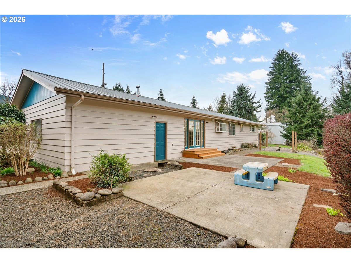 1611 Main Street Lyons, OR 97358 - Photo 39 of 48 a backyard of a house with table and chairs with wooden fence
