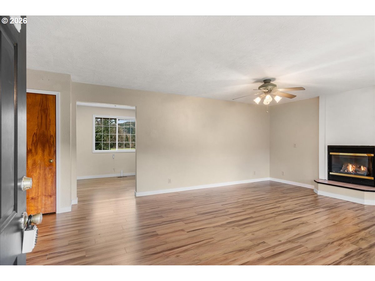 1611 Main Street Lyons, OR 97358 - Photo 7 of 48 a view of an empty room with wooden floor and a window
