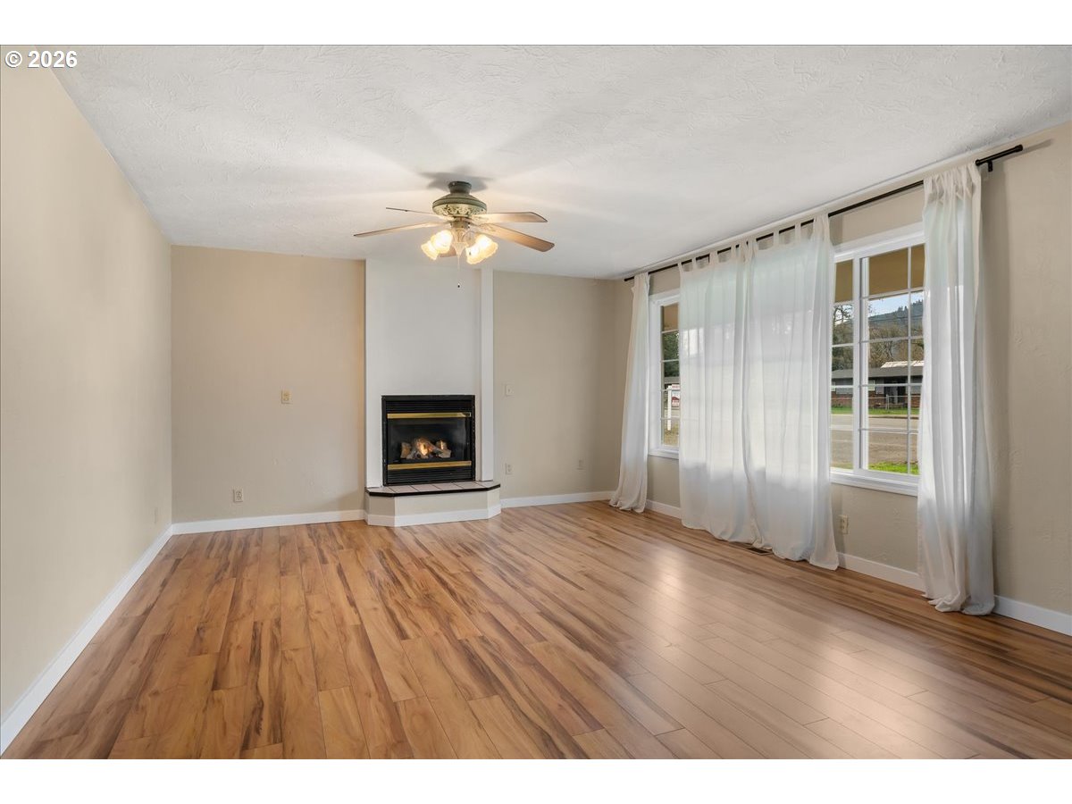 1611 Main Street Lyons, OR 97358 - Photo 9 of 48 an empty room with windows and fireplace