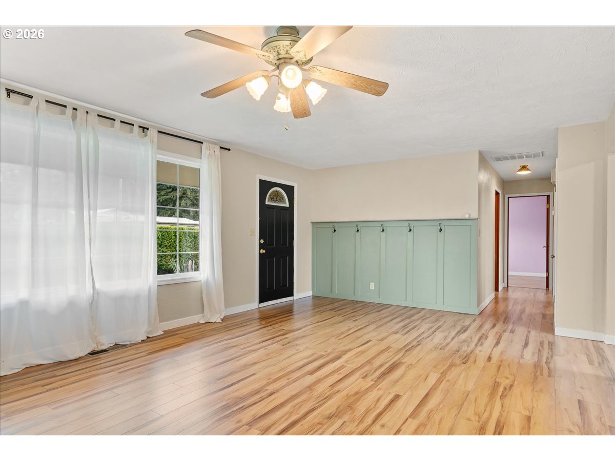 1611 Main Street Lyons, OR 97358 - Photo 10 of 48 a view of an empty room with wooden floor and a window