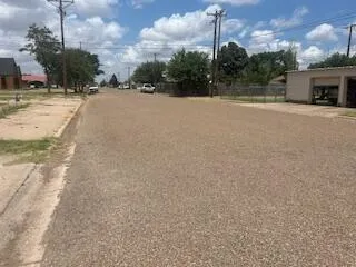 a view of a house with a yard and a garage