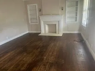 a view of empty room with a fireplace