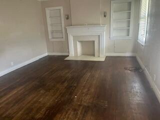206 South White Street Floydada, TX 79235 - Photo 2 of 16 a view of empty room with a fireplace