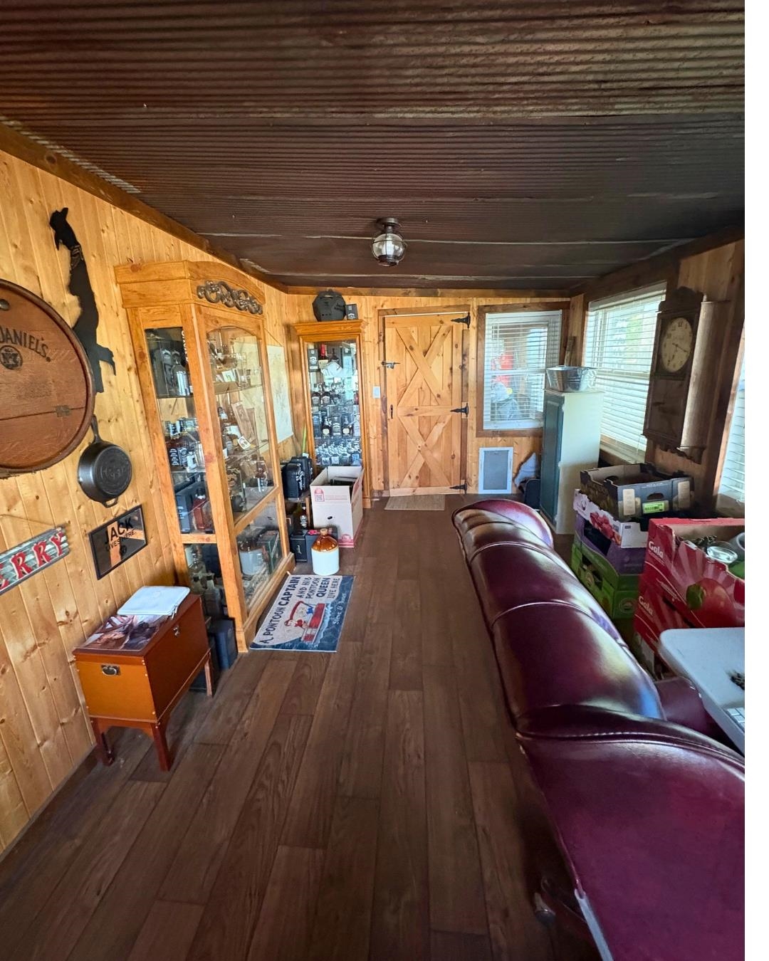 772 Rushing Road Michie, TN 38357 - Photo 5 of 19 Wood-finish flooring with plank-style wall paneling and a corrugated metal ceiling