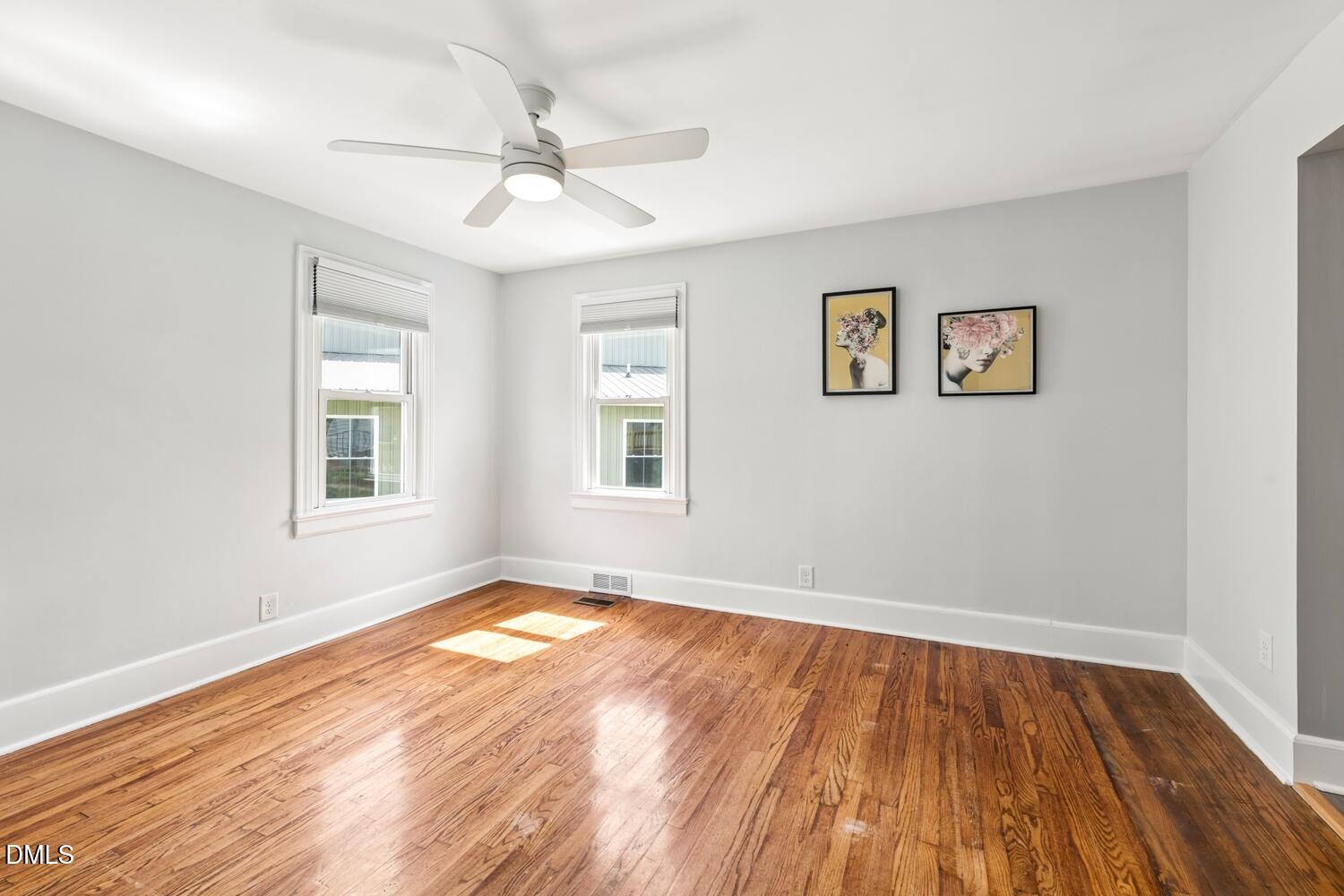 414 South Maple Street Graham, NC 27253 - Photo 12 of 42 a view of empty room with wooden floor and fan