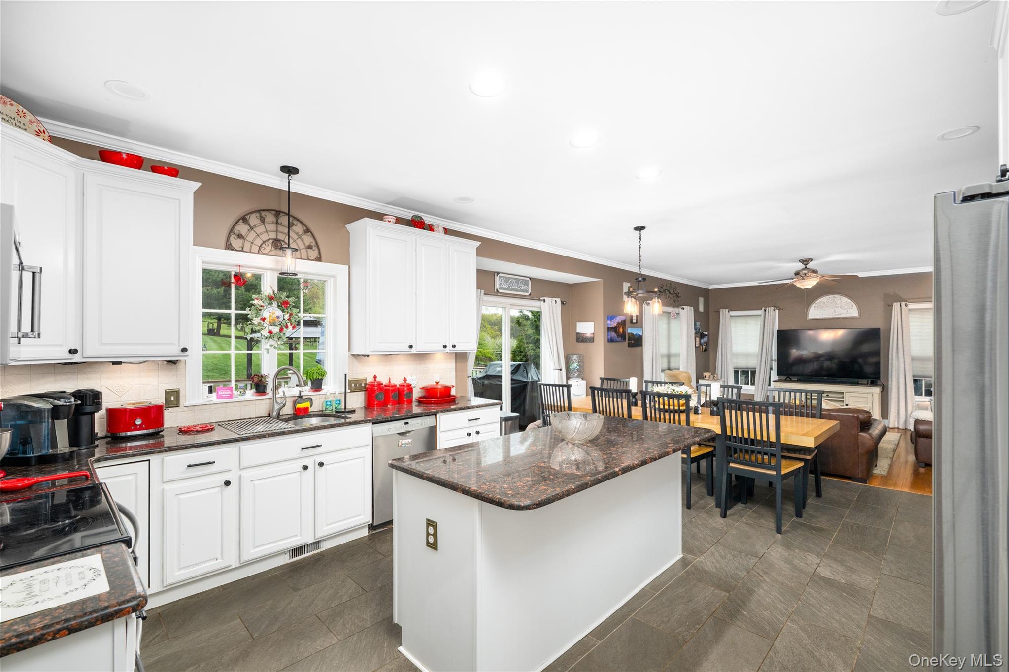 60 Idlewild Road Marlboro, NY 12542 - Photo 13 of 37 Open-concept kitchen featuring white cabinetry, granite countertops, a central island with integrated storage, and large format tile flooring