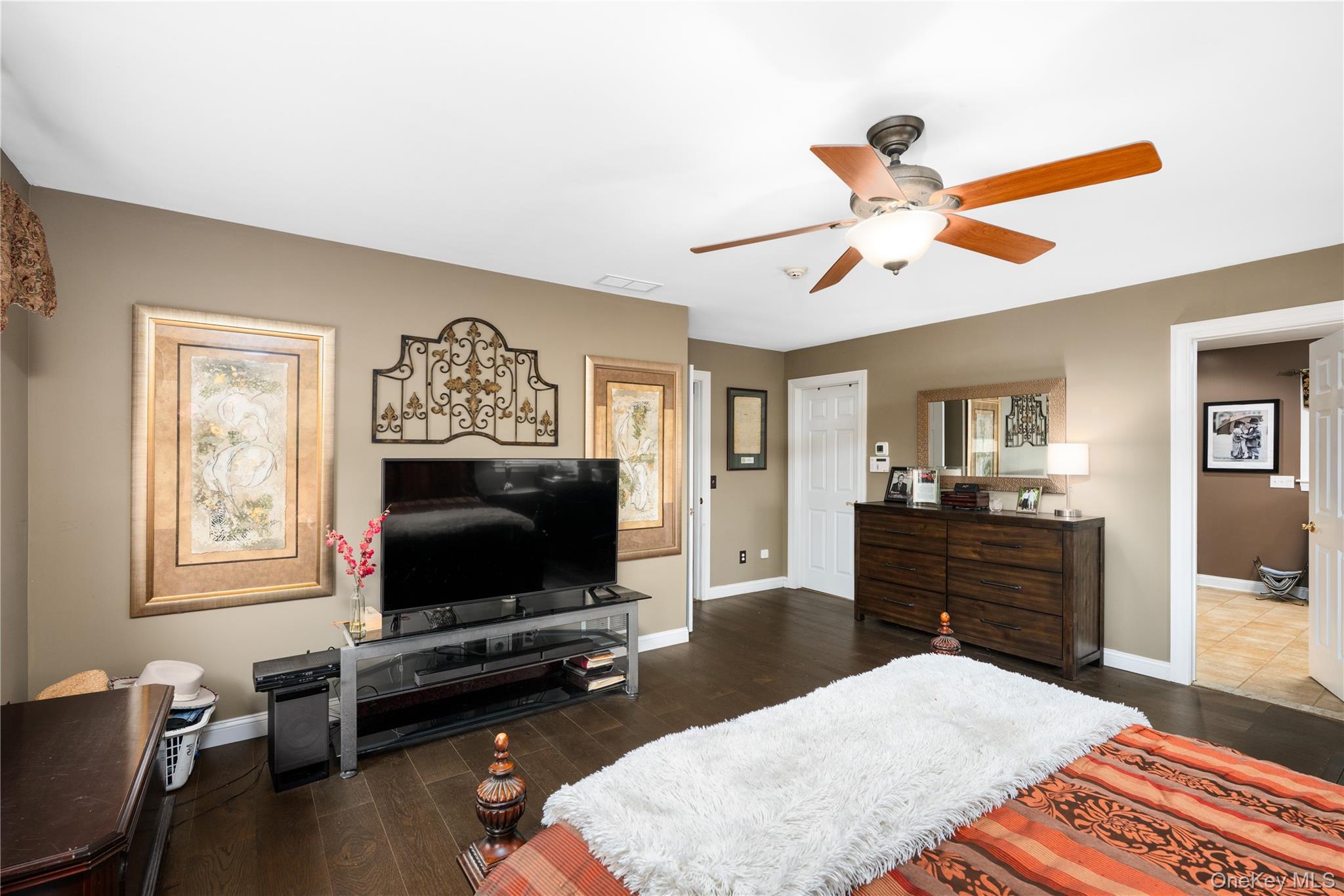 60 Idlewild Road Marlboro, NY 12542 - Photo 19 of 37 Spacious room featuring dark wood-finish flooring, a ceiling fan with integrated lighting, and a neutral wall color