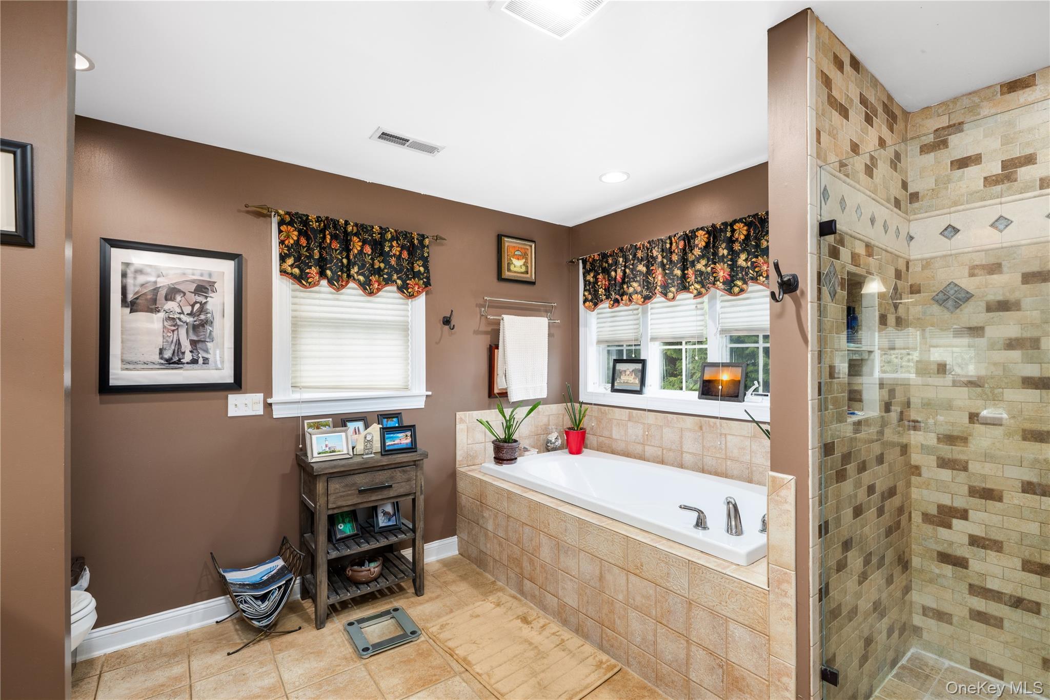 60 Idlewild Road Marlboro, NY 12542 - Photo 20 of 37 Bathroom featuring a built-in jetted soaker tub with tile surround, a glass-enclosed shower with tile work, recessed lighting, and a window with blinds