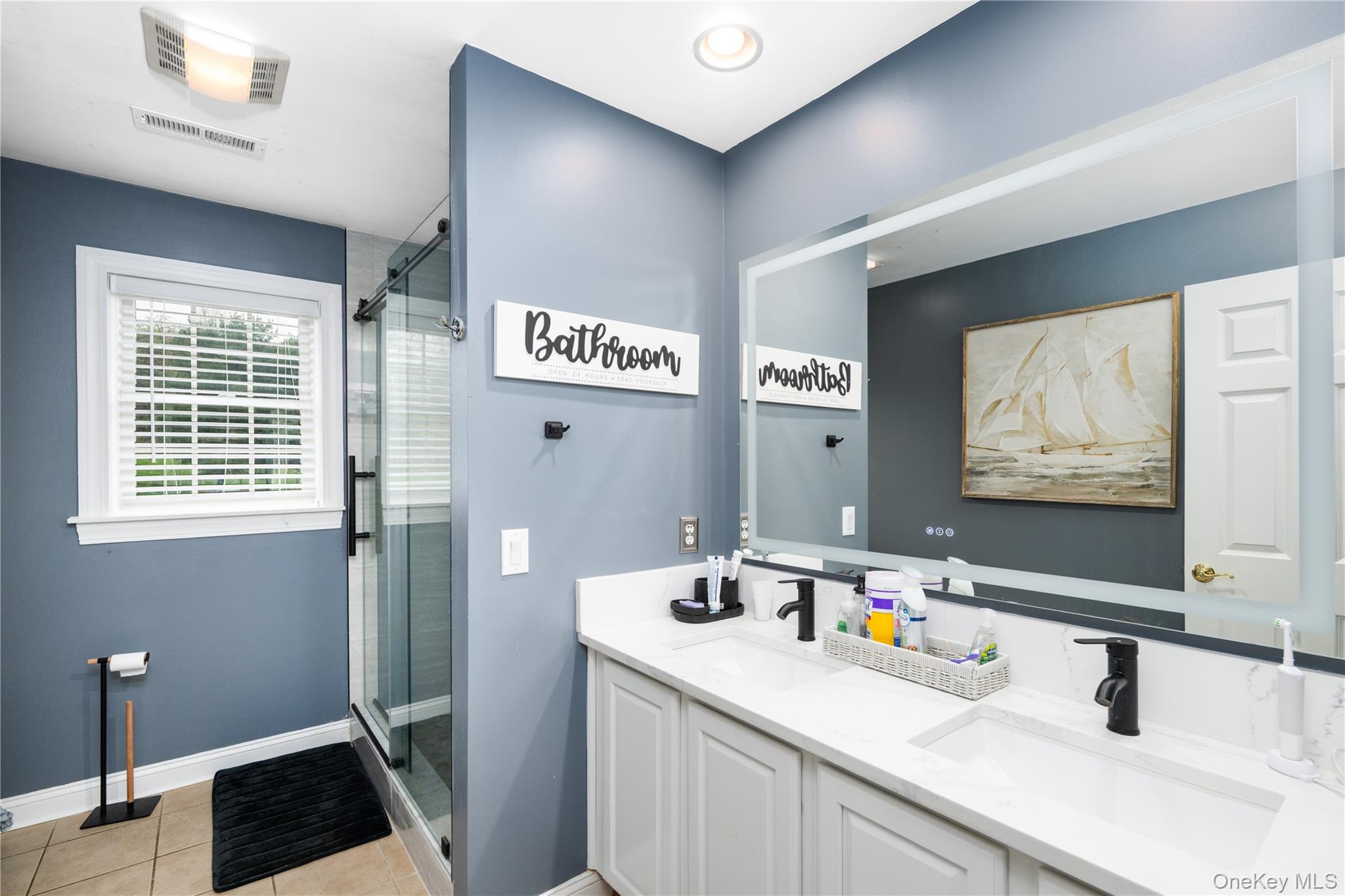 60 Idlewild Road Marlboro, NY 12542 - Photo 28 of 37 Dual vanity with white cabinetry, integrated granite counter sinks, and matte black fixtures