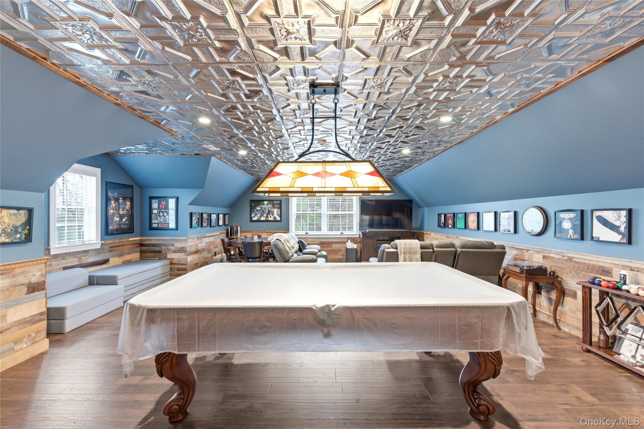 60 Idlewild Road Marlboro, NY 12542 - Photo 29 of 37 Spacious recreation room featuring wood-finish flooring, a decorative embossed tin ceiling, and a stained glass light fixture
